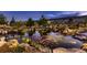 Scenic view of a backyard pond with lush greenery, rock formations, and serene water reflections at 8661 Hunters Hill Ln, Littleton, CO 80125