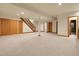 Large finished basement with recessed lighting, storage closets, and stairs to the upper level at 6321 S Harrison Ct, Centennial, CO 80121