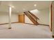 Finished basement featuring a staircase and multiple closets for ample storage at 6321 S Harrison Ct, Centennial, CO 80121
