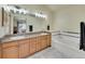 Bright bathroom featuring a double sink vanity and a relaxing soaking tub at 6321 S Harrison Ct, Centennial, CO 80121