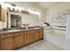Relaxing bathroom complete with double sinks, granite countertops, and a luxurious soaking tub at 6321 S Harrison Ct, Centennial, CO 80121
