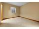 This bedroom has neutral walls and carpet with minimal features at 6321 S Harrison Ct, Centennial, CO 80121