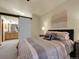 Comfortable bedroom featuring stylish decor and a sliding barn door leading to the bathroom at 6321 S Harrison Ct, Centennial, CO 80121