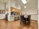 Bright dining area with stylish lighting, wood floors, and seamless kitchen access at 6321 S Harrison Ct, Centennial, CO 80121