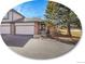 Charming townhome featuring a two-car garage, landscaped front yard, and inviting entryway at 6321 S Harrison Ct, Centennial, CO 80121