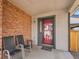 Cozy covered front porch, perfect for relaxing with chairs and a small table at 6321 S Harrison Ct, Centennial, CO 80121