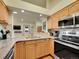 Modern kitchen featuring granite countertops, stainless steel appliances, and wooden cabinetry at 6321 S Harrison Ct, Centennial, CO 80121