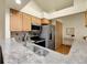 Modern kitchen featuring granite countertops and stainless steel appliances at 6321 S Harrison Ct, Centennial, CO 80121
