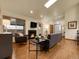 Inviting living room boasts a cozy fireplace, wood floors, and an abundance of natural light at 6321 S Harrison Ct, Centennial, CO 80121