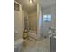 Modest bathroom with tiled shower, toilet, and vanity, bathed in natural light at 240 N 4Th Ave, Brighton, CO 80601