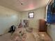 Bedroom with neutral walls and clutter, illuminated by a window at 240 N 4Th Ave, Brighton, CO 80601