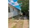 Home's driveway beside home, shaded with a large tree, has room for parking at 240 N 4Th Ave, Brighton, CO 80601