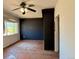 Empty living room features a ceiling fan and a large window for natural light at 240 N 4Th Ave, Brighton, CO 80601