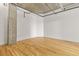 Bright bedroom with hardwood floors, neutral walls, and exposed ceiling at 2020 Arapahoe St # 970, Denver, CO 80205