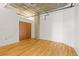 Open bedroom with hardwood floors and exposed ceiling at 2020 Arapahoe St # 970, Denver, CO 80205