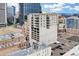 Large building with urban views, featuring a parking garage and balconies on a sunny day at 2020 Arapahoe St # 970, Denver, CO 80205