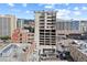 Multi-story building in an urban area, with parking garage and mountain views in the background at 2020 Arapahoe St # 970, Denver, CO 80205