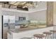 Contemporary kitchen with stainless steel appliances, tile backsplash, and seating area at 2020 Arapahoe St # 970, Denver, CO 80205
