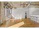 Bright, spacious living room with hardwood floors, exposed concrete, and a unique light fixture at 2020 Arapahoe St # 970, Denver, CO 80205