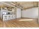 Open-concept living room and kitchen with hardwood floors and modern lighting at 2020 Arapahoe St # 970, Denver, CO 80205
