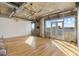 Bright living room boasts hardwood floors, exposed ductwork, and floor to ceiling windows with city views at 2020 Arapahoe St # 970, Denver, CO 80205