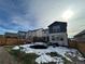 Spacious backyard with a trampoline, playground, and snowy landscape at 27869 E 7Th Pl, Aurora, CO 80018