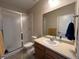 Clean bathroom with shower, toilet and vanity with a large mirror at 27869 E 7Th Pl, Aurora, CO 80018