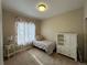 Cozy bedroom with a twin bed, window, and white storage cabinet at 27869 E 7Th Pl, Aurora, CO 80018