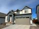 Two-story house with gray and blue exterior, attached garage, and landscaping at 27869 E 7Th Pl, Aurora, CO 80018