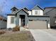 Two-story house with gray and blue exterior, attached garage, and landscaping at 27869 E 7Th Pl, Aurora, CO 80018