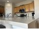 Modern kitchen with stainless steel appliances and light wood cabinets at 27869 E 7Th Pl, Aurora, CO 80018