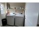 Convenient laundry room with washer, dryer, and overhead shelving at 27869 E 7Th Pl, Aurora, CO 80018