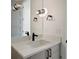 Modern bathroom featuring a sleek vanity with a dark faucet, quartz countertops, and a stylish light fixture at 6176 Oxford Peak Ln, Castle Rock, CO 80108