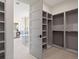View of a walk-in closet connected to a luxurious bathroom with a soaking tub and double vanity at 6176 Oxford Peak Ln, Castle Rock, CO 80108