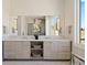Bathroom vanity with double sinks, marble countertop, decorative lighting, and storage space at 6176 Oxford Peak Ln, Castle Rock, CO 80108