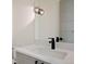 Bathroom featuring a modern vanity with a dark faucet, gray-toned cabinets, and a sleek light fixture at 6176 Oxford Peak Ln, Castle Rock, CO 80108