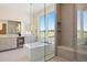Bright bathroom featuring a soaking tub, glass shower, and double vanity with a view at 6176 Oxford Peak Ln, Castle Rock, CO 80108