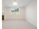 Minimalist bedroom with a large window offering natural light and views of the outdoors at 6176 Oxford Peak Ln, Castle Rock, CO 80108