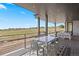 Covered deck featuring a modern dining set and scenic views at 6176 Oxford Peak Ln, Castle Rock, CO 80108