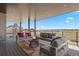 Covered outdoor deck with comfortable seating and scenic views at 6176 Oxford Peak Ln, Castle Rock, CO 80108