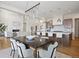 Open concept dining area leading to kitchen, with elegant lighting and ample natural light at 6176 Oxford Peak Ln, Castle Rock, CO 80108