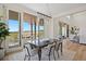 Elegant dining area with view to outdoor deck, stylish lighting, and neutral decor at 6176 Oxford Peak Ln, Castle Rock, CO 80108