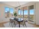 Dining room features lots of light with views, modern chandelier, and neutral colored chairs at 6176 Oxford Peak Ln, Castle Rock, CO 80108
