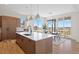 Island kitchen with stainless appliances, white countertop, and dining area at 6176 Oxford Peak Ln, Castle Rock, CO 80108