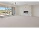 Living room featuring a modern fireplace, large sliding doors with natural light, and neutral carpeting at 6176 Oxford Peak Ln, Castle Rock, CO 80108