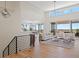 Open-concept living room with modern lighting and large windows at 6176 Oxford Peak Ln, Castle Rock, CO 80108