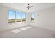 Bright and airy living room with large windows offering scenic views and modern lighting fixtures at 6176 Oxford Peak Ln, Castle Rock, CO 80108