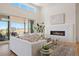 Bright living room features fireplace, stylish furniture, and outdoor access at 6176 Oxford Peak Ln, Castle Rock, CO 80108