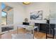 Bright home office with modern desk, built-in shelves, and natural light at 6176 Oxford Peak Ln, Castle Rock, CO 80108