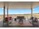Inviting covered patio featuring comfortable seating and scenic views at 6176 Oxford Peak Ln, Castle Rock, CO 80108